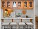 Kitchen features a breakfast bar with seating, wood cabinets and tile backsplash at 10200 Amsterdam Dr, Mount Pleasant, NC 28124