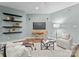 Inviting living room with wood-style flooring, floating shelves, and a cozy seating arrangement at 10200 Amsterdam Dr, Mount Pleasant, NC 28124