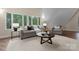 Comfortable living room with natural light from large windows, featuring neutral tones and stylish furnishings at 10200 Amsterdam Dr, Mount Pleasant, NC 28124