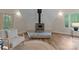 Cozy living room featuring a wood-burning stove on a stone base and a comfortable chair at 10200 Amsterdam Dr, Mount Pleasant, NC 28124