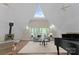 Bright living room featuring a vaulted ceiling, wood floors, and a charming wood-burning stove at 10200 Amsterdam Dr, Mount Pleasant, NC 28124