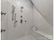 Modern walk-in shower featuring multiple shower heads, a sleek design, and a built-in seat at 10200 Amsterdam Dr, Mount Pleasant, NC 28124