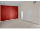 Bedroom with red accent wall and access to bathroom at 1024 Knob Creek Ln, Fort Mill, SC 29708