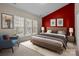 Main bedroom with red accent wall and ample natural light at 1024 Knob Creek Ln, Tega Cay, SC 29708