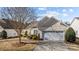 House exterior featuring a two-car garage and manicured landscaping at 1024 Knob Creek Ln, Tega Cay, SC 29708