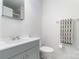 Bathroom featuring a gray vanity, toilet, and towel bar with modern towel at 10240 Rose Meadow Ln # D, Charlotte, NC 28277