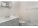 Clean bathroom with gray vanity, toilet, and shower/tub combo at 10240 Rose Meadow Ln # D, Charlotte, NC 28277