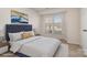 Staged bedroom with a bed, nightstands, and natural lighting at 10240 Rose Meadow Ln # D, Charlotte, NC 28277