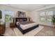 Bedroom staged with a bed, side tables and lamps, dresser, and carpet at 10240 Rose Meadow Ln # D, Charlotte, NC 28277