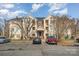 Brick condo building with ample parking and landscaping at 10240 Rose Meadow Ln # D, Charlotte, NC 28277