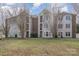 Brick building with multiple units and landscaping at 10240 Rose Meadow Ln # D, Charlotte, NC 28277