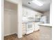 Bright kitchen featuring white cabinets, granite countertops, and modern appliances at 10240 Rose Meadow Ln # D, Charlotte, NC 28277