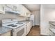 White kitchen with granite countertops and appliances at 10240 Rose Meadow Ln # D, Charlotte, NC 28277