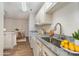 Well-lit kitchen with white cabinets, stainless steel sink, and granite countertops at 10240 Rose Meadow Ln # D, Charlotte, NC 28277