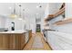 Modern kitchen with white cabinets, marble island, and herringbone backsplash at 109 Myers Port Way # 2, Mooresville, NC 28117