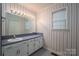 Bathroom features a vanity with a single sink and vintage wallpaper at 110 Robin Rd, Lincolnton, NC 28092