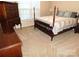 Bedroom featuring a four-poster bed, carpet, neutral paint and natural light from a window at 110 Robin Rd, Lincolnton, NC 28092