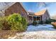 Brick house with a covered porch, partially covered in snow, and winter landscaping at 110 Robin Rd, Lincolnton, NC 28092