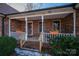 Brick front porch with white railings, planters, and a wooden front door at 110 Robin Rd, Lincolnton, NC 28092