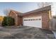 Brick home's attached garage with white door at 110 Robin Rd, Lincolnton, NC 28092