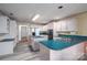 L-shaped kitchen with teal countertops and white cabinets at 110 Robin Rd, Lincolnton, NC 28092