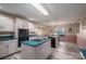 View of kitchen with teal island, white cabinets, and appliances at 110 Robin Rd, Lincolnton, NC 28092