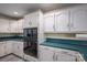 Kitchen with white cabinets, teal countertops and built-in appliances at 110 Robin Rd, Lincolnton, NC 28092