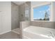 Spa-like bathroom with soaking tub, glass shower, and window with a view at 12060 Mariners Cove Ct, Lancaster, SC 29720