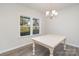 Dining room with hardwood floors, chandelier, and a white table at 12060 Mariners Cove Ct, Lancaster, SC 29720