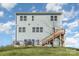 Three-story light blue house with a deck and wooden stairs at 12060 Mariners Cove Ct, Lancaster, SC 29720