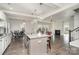 Open concept kitchen with an island, white cabinets and hardwood floors at 12060 Mariners Cove Ct, Lancaster, SC 29720