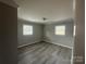 Second bedroom with neutral walls and laminate flooring at 1219 Stevens Cir, Gastonia, NC 28054