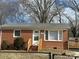 Brick ranch home with a fenced yard and deck at 1219 Stevens Cir, Gastonia, NC 28054