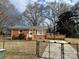 Brick ranch home with a fenced yard and deck at 1219 Stevens Cir, Gastonia, NC 28054