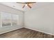 Bright bedroom with wood-look floors and window at 124 Zolder Ln # 15, Mooresville, NC 28117