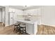 White kitchen with quartz island and gold fixtures at 124 Zolder Ln # 15, Mooresville, NC 28117