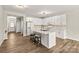 White kitchen with quartz island and gold fixtures at 124 Zolder Ln # 15, Mooresville, NC 28117