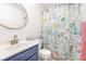 Bathroom with floral shower curtain and blue vanity at 14023 Kedleston Rd, Huntersville, NC 28078