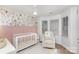 Bedroom with floral wall and comfy rocking chair at 14023 Kedleston Rd, Huntersville, NC 28078