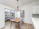 Charming dining area with wood table and chairs, access to deck at 14023 Kedleston Rd, Huntersville, NC 28078