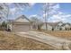 Brick and white sided ranch home with gray garage door at 14023 Kedleston Rd, Huntersville, NC 28078