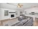 Bright living room features a fireplace and L-shaped sofa, open to kitchen at 14023 Kedleston Rd, Huntersville, NC 28078