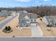 Two-story house, gray roof, blue and beige siding, front yard landscaping, driveway at 1503 Brooksland Pl, Waxhaw, NC 28173