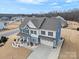 Two-story house, gray roof, blue and beige siding, front yard landscaping, driveway at 1503 Brooksland Pl, Waxhaw, NC 28173