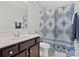 Bathroom with dark brown vanity and patterned shower curtain at 1503 Brooksland Pl, Waxhaw, NC 28173