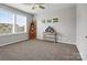 Bright bedroom with carpet, ceiling fan, and decorative shelving at 1503 Brooksland Pl, Waxhaw, NC 28173