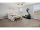 Spacious bedroom with elliptical machine and large bed at 1503 Brooksland Pl, Waxhaw, NC 28173