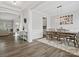 Spacious dining room with hardwood floors, a chandelier, and access to the kitchen at 1503 Brooksland Pl, Waxhaw, NC 28173