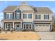 Two-story house with blue and beige siding, a two-car garage, and landscaping at 1503 Brooksland Pl, Waxhaw, NC 28173