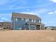 Two-story home with blue siding and covered patio at 1503 Brooksland Pl, Waxhaw, NC 28173